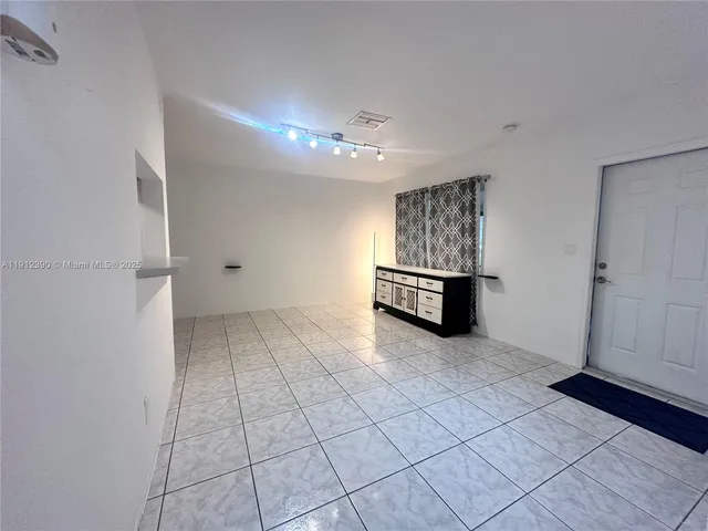 a front view of house with a garden