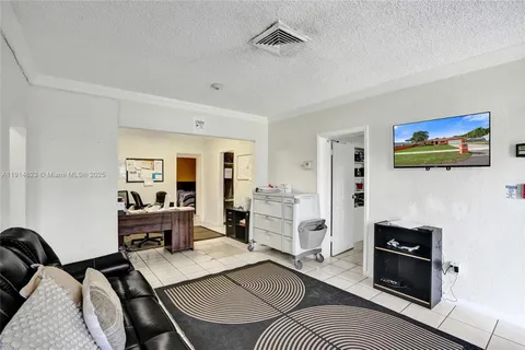 a living room with furniture a rug and a bookshelf