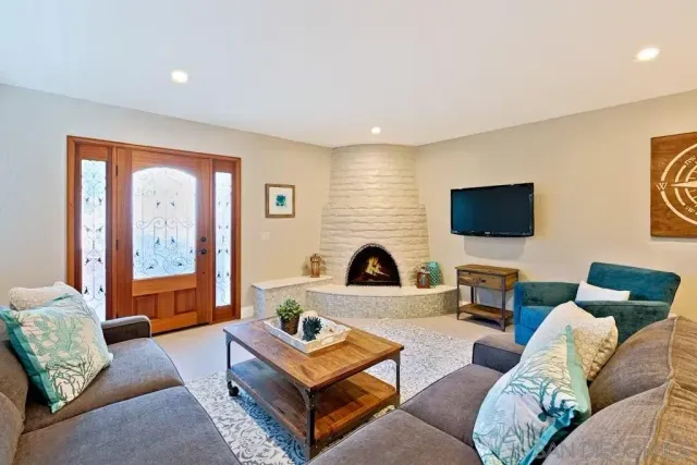 a living room with furniture and a flat screen tv