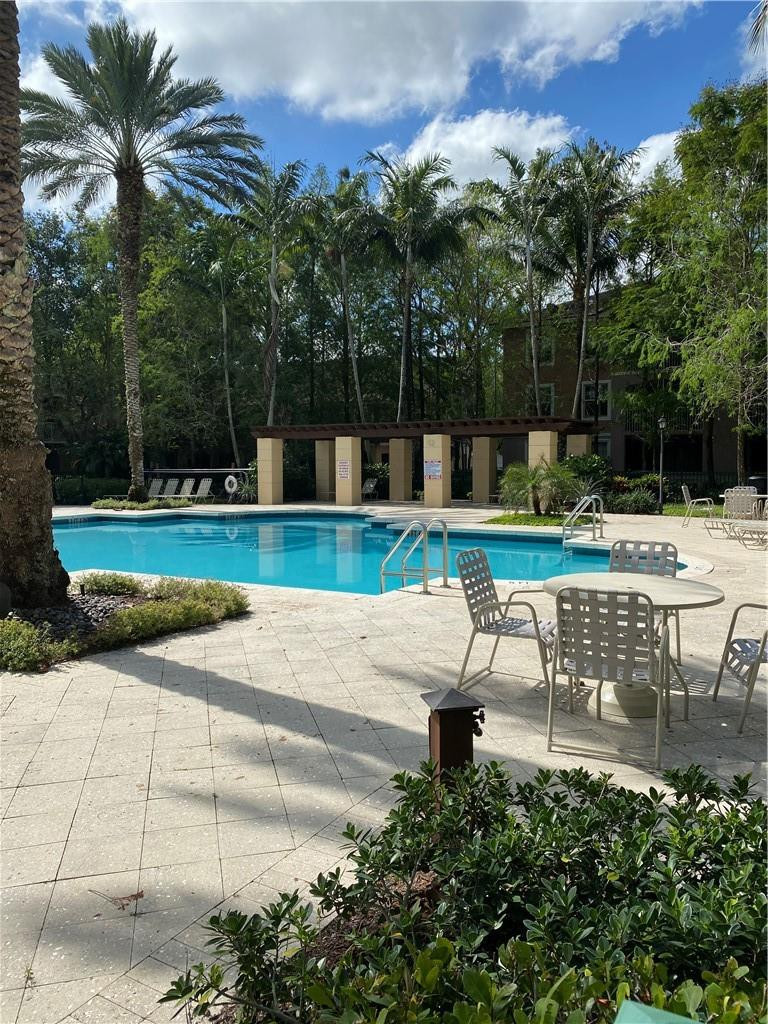 6820 West Sample Road, Unit 6820 Coral Springs, FL 33067 - Photo 11 of 13 a view of a yard with a bench