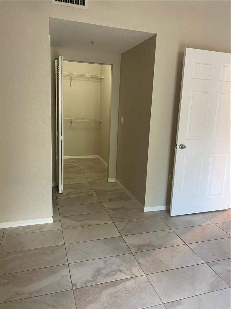 6820 West Sample Road, Unit 6820 Coral Springs, FL 33067 - Photo 3 of 13 an empty room with a door