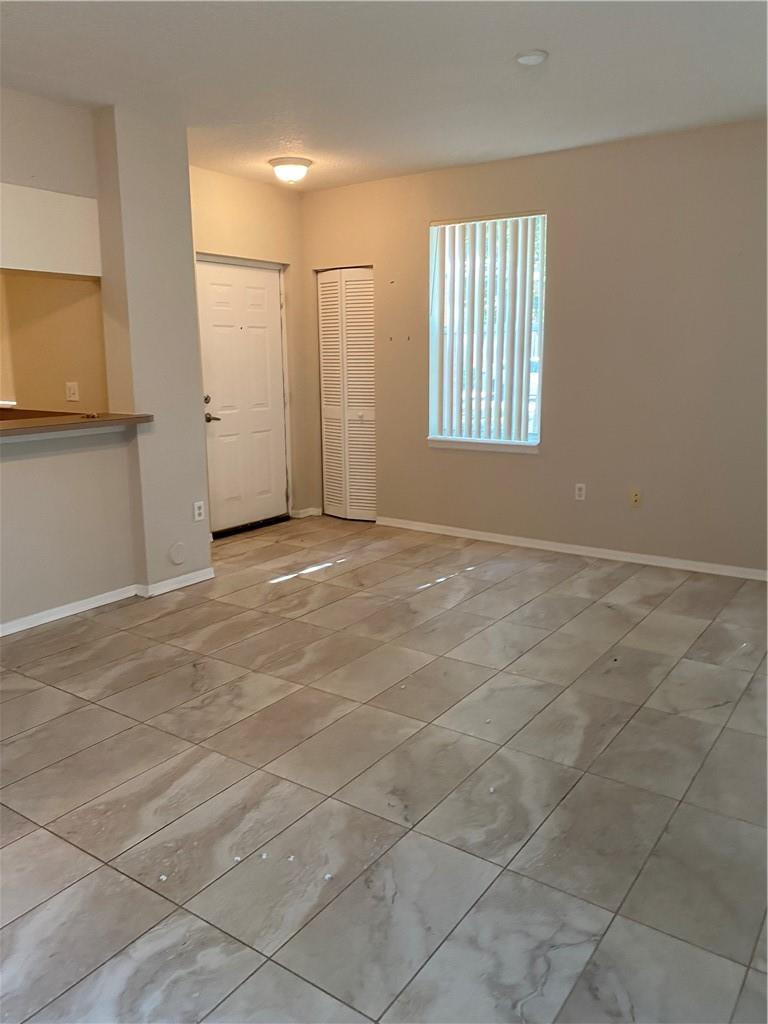 6820 West Sample Road, Unit 6820 Coral Springs, FL 33067 - Photo 7 of 13 an empty room with windows and closet