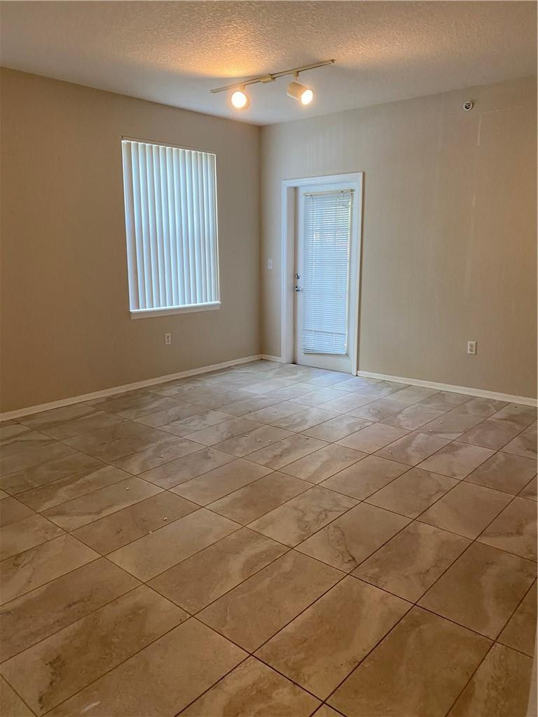 6820 West Sample Road, Unit 6820 Coral Springs, FL 33067 - Photo 9 of 13 a view of an empty room with windows