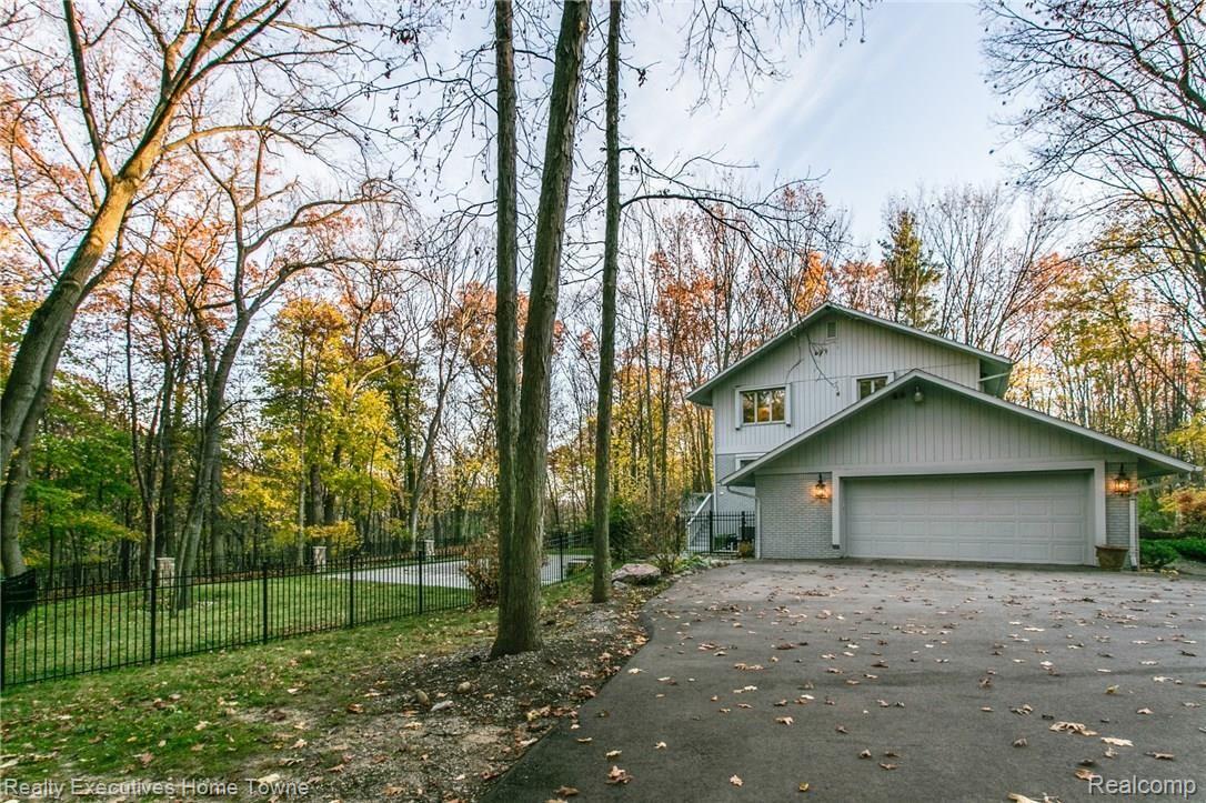 1130 Burnham Road Bloomfield Hills, MI 48304 - Photo 56 of 56 Lots of extra parking outside 2 1/2 car garage - with view of yard and pool.