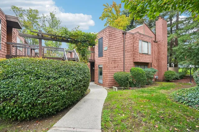 a view of a house with a yard and pathway