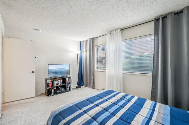 a bedroom with a bed closet and a window