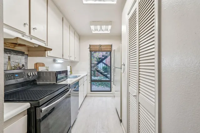 a kitchen with a sink and cabinets