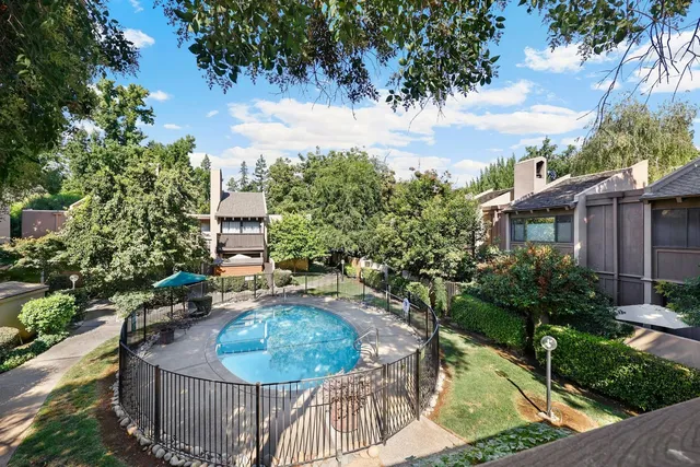 a backyard of a house with yard and trampoline