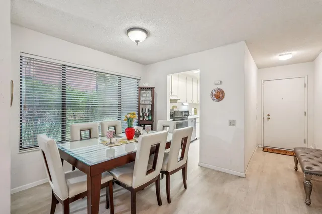 a view of a dining room with furniture and window