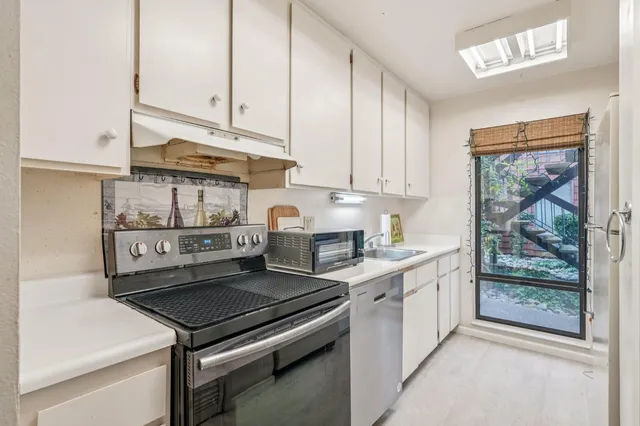 a kitchen with stainless steel appliances granite countertop a stove and a refrigerator