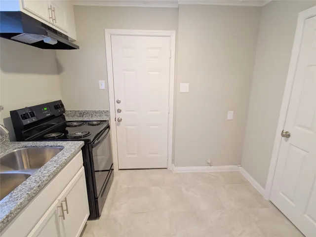 a kitchen that has a sink and a stove