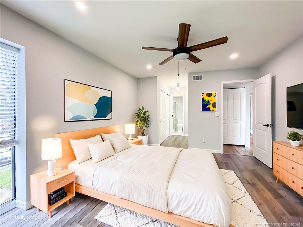800 Northwest Fork Road, Unit 107 Stuart, FL 34994 - Photo 3 of 21 a bedroom with a bed and a flat screen tv