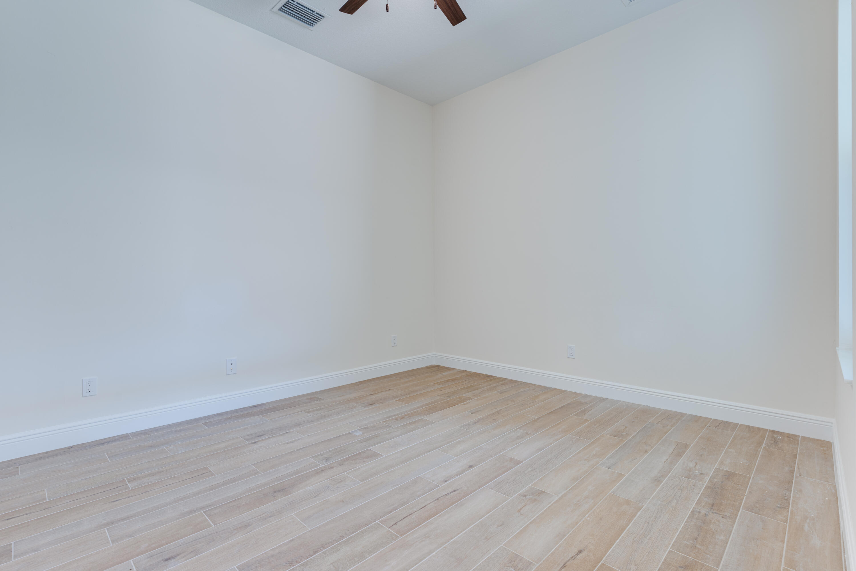 1805 Bridgepointe Circle, Unit 3 Vero Beach, FL 32967 - Photo 12 of 28 a view of an empty room with wooden floor