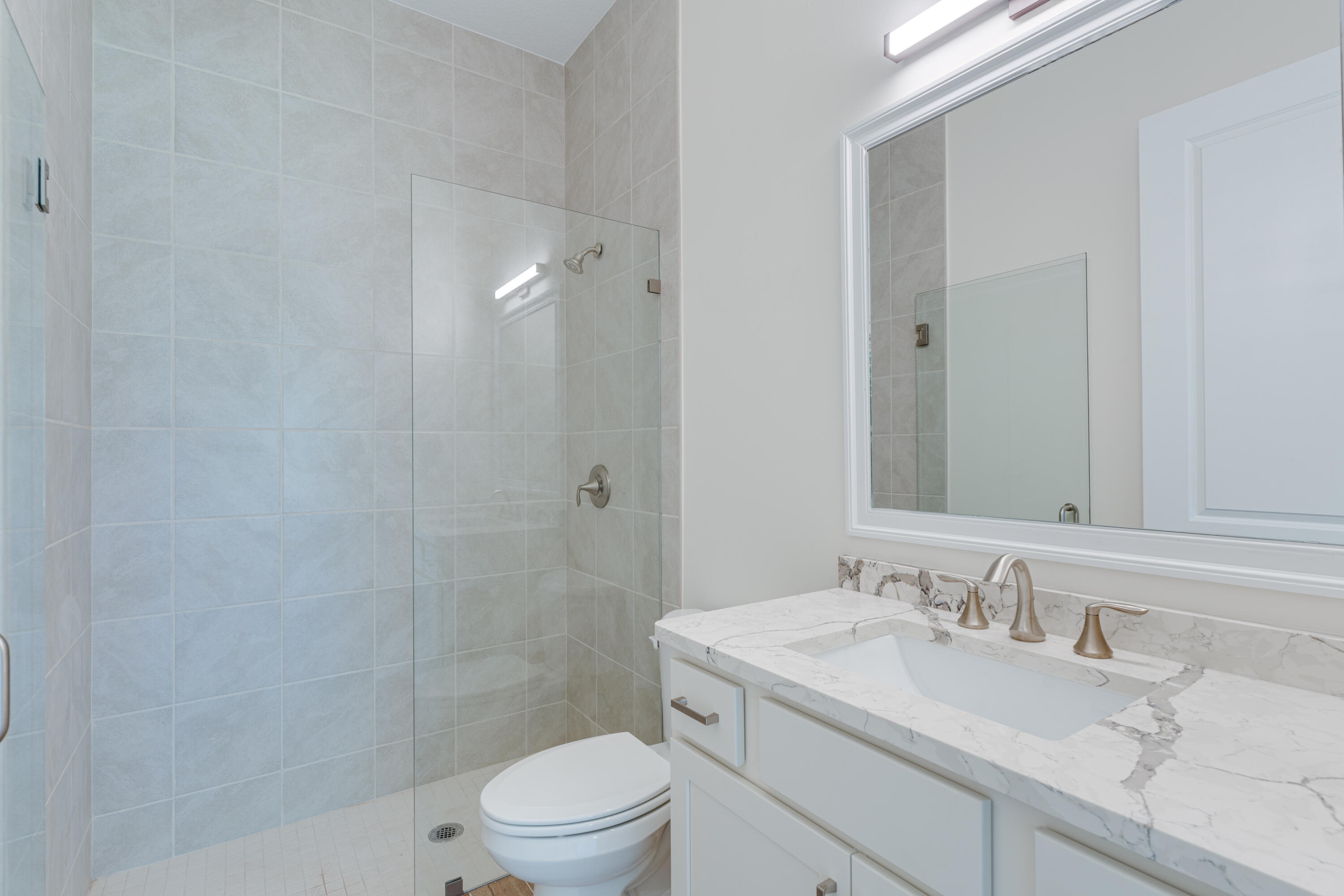 1805 Bridgepointe Circle, Unit 3 Vero Beach, FL 32967 - Photo 13 of 28 a bathroom with a sink toilet and shower