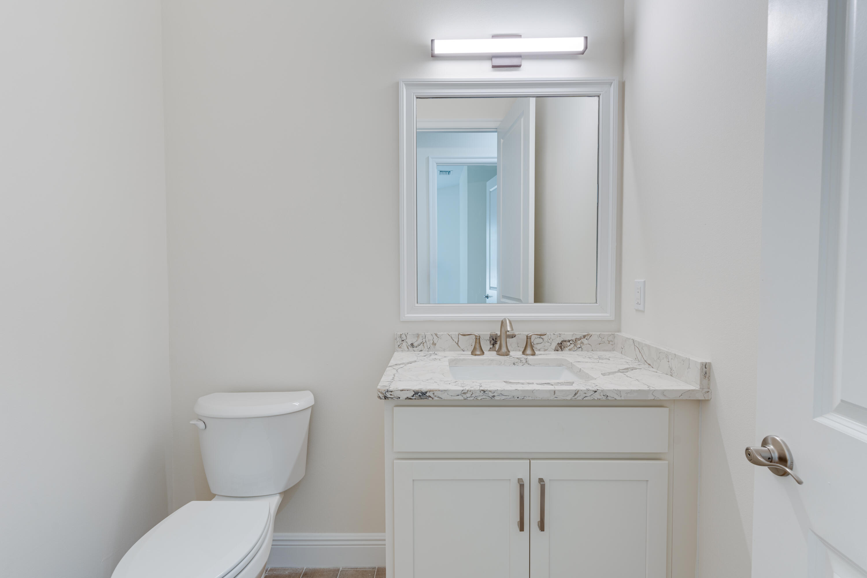 1805 Bridgepointe Circle, Unit 3 Vero Beach, FL 32967 - Photo 14 of 28 a bathroom with a toilet sink and mirror