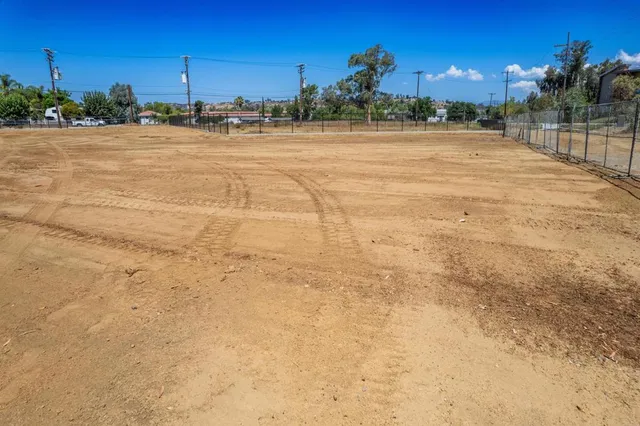 a front view of a building with trees