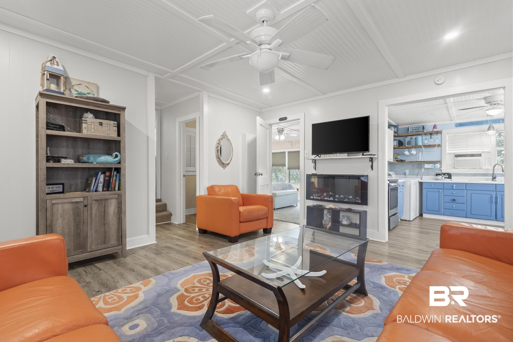 562 Veterans Road Gulf Shores, AL 36542 - Photo 12 of 32 Living room with a ceiling fan, light wood-style flooring, stairs, ornamental molding, and baseboards