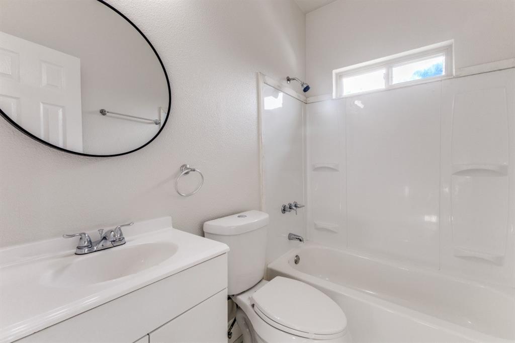 711 South 3rd Avenue East Dawson, TX 76639 - Photo 11 of 12 a bathroom with a sink a toilet and a mirror