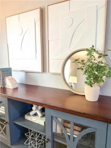 a vase of flowers sitting on a table with a kitchen island