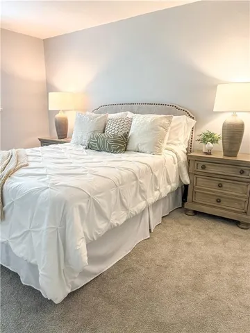 a bedroom with a bed and lamp
