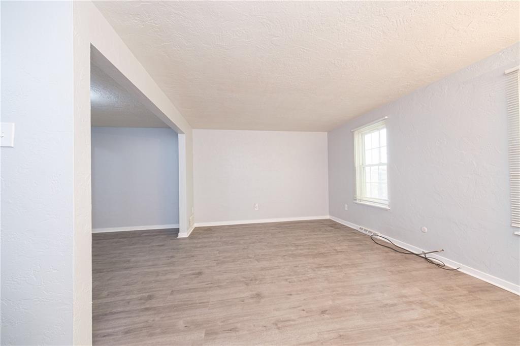 722 Mercer Street Pittsburgh, PA 15219 - Photo 37 of 41 an empty room with wooden floor and windows