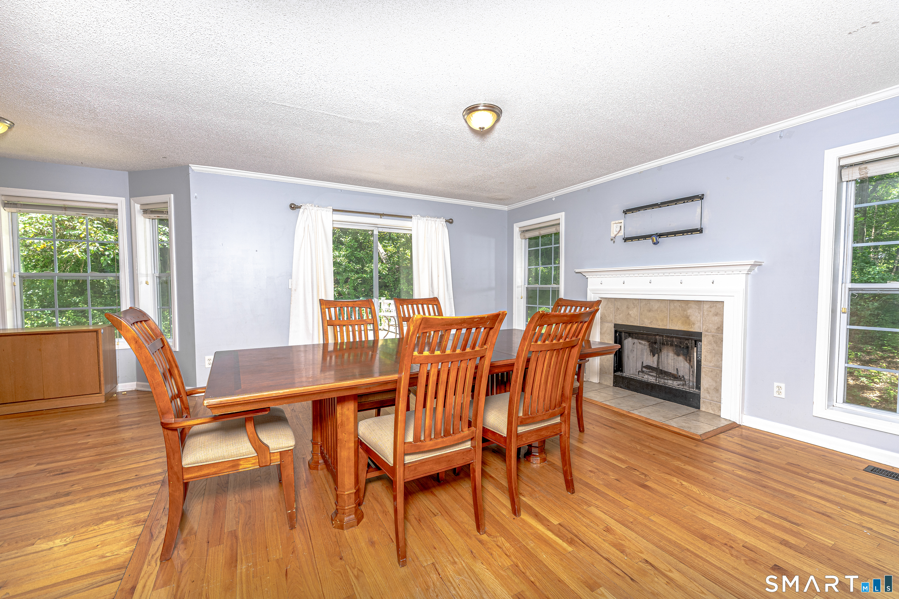 20 Gaylord Mountain Road Hamden, CT 06518 - Photo 16 of 37 a dining room with furniture a fireplace and wooden floor