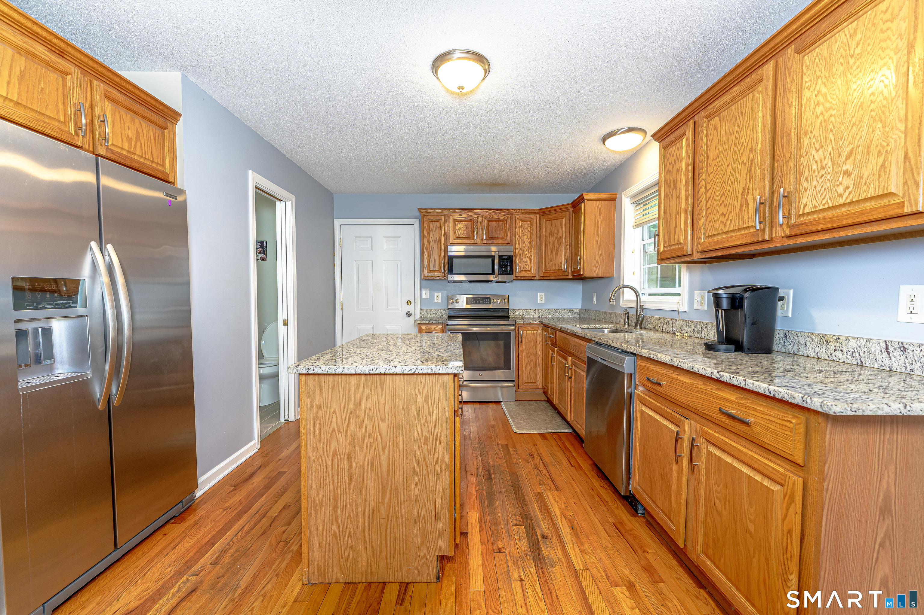 20 Gaylord Mountain Road Hamden, CT 06518 - Photo 19 of 37 a large kitchen with stainless steel appliances granite countertop a stove a sink dishwasher and a refrigerator