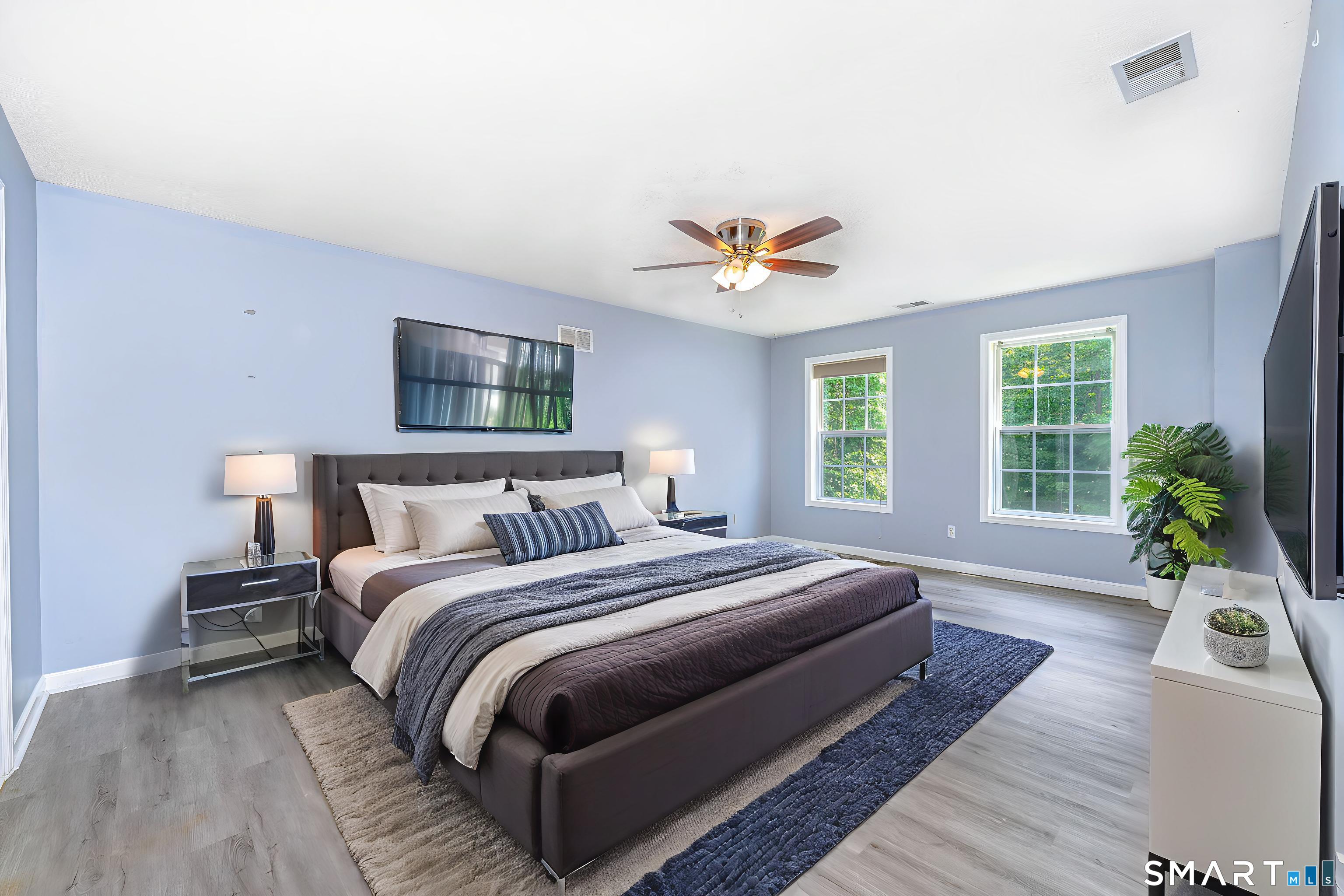 20 Gaylord Mountain Road Hamden, CT 06518 - Photo 22 of 37 a bedroom with a large bed a potted plant and a window