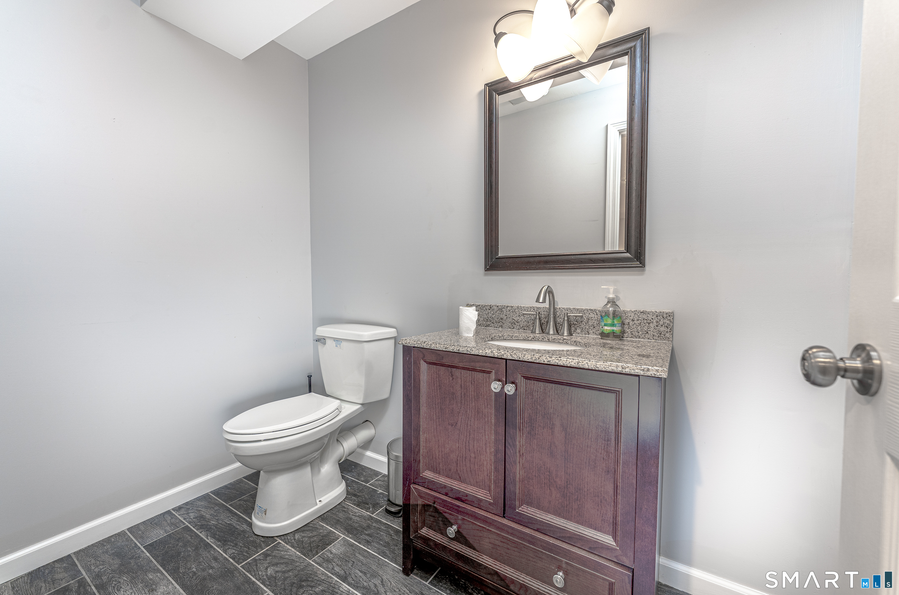 20 Gaylord Mountain Road Hamden, CT 06518 - Photo 35 of 37 a bathroom with a toilet sink vanity and mirror