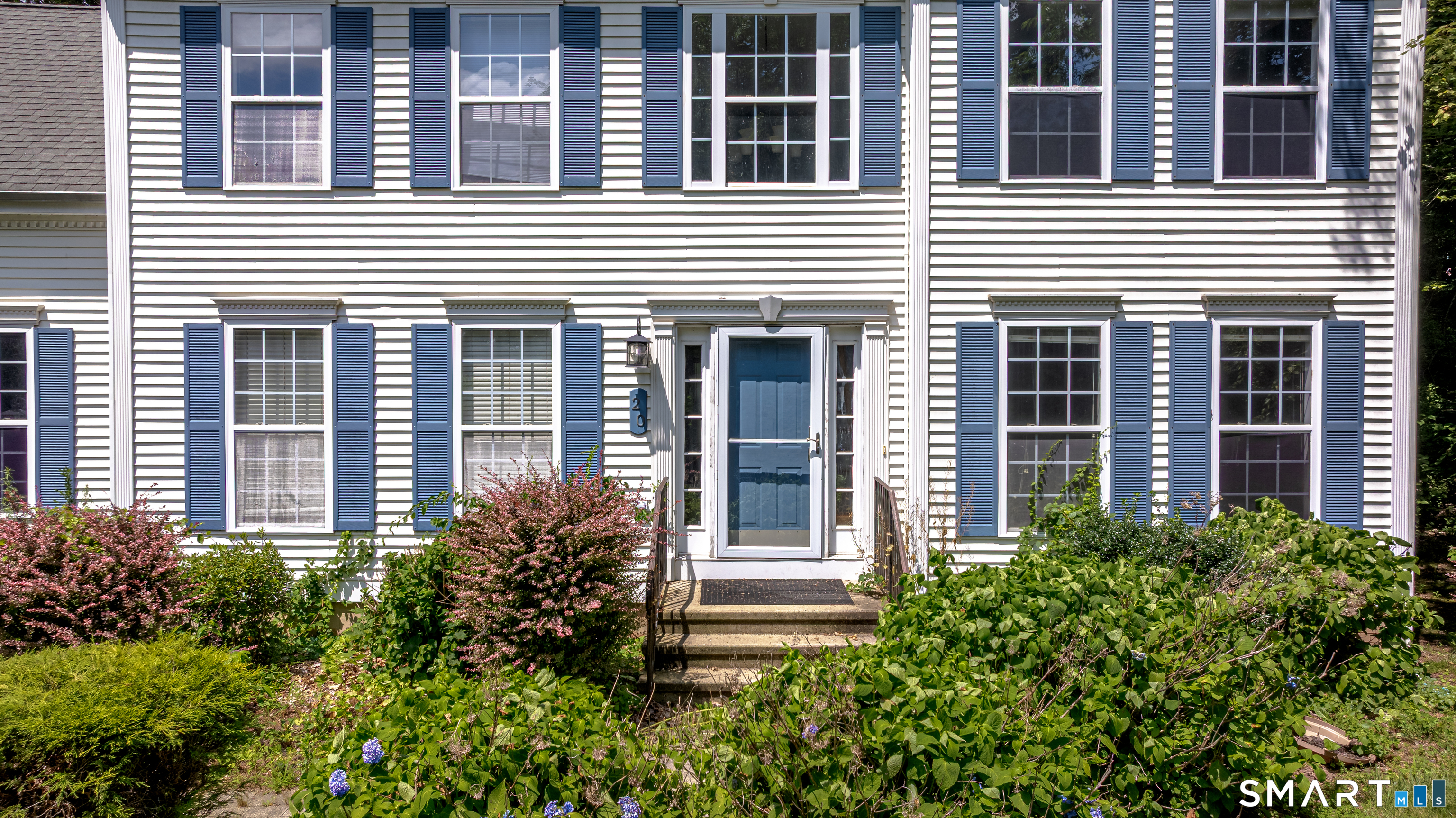 20 Gaylord Mountain Road Hamden, CT 06518 - Photo 5 of 37 a view of a house with potted plants and a large window