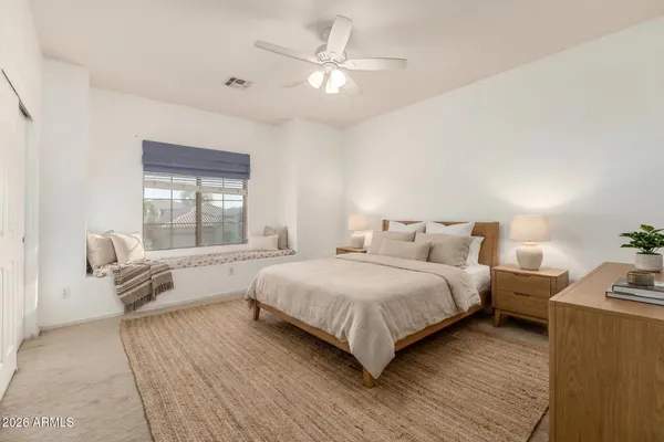 a spacious bedroom with a bed and a couch