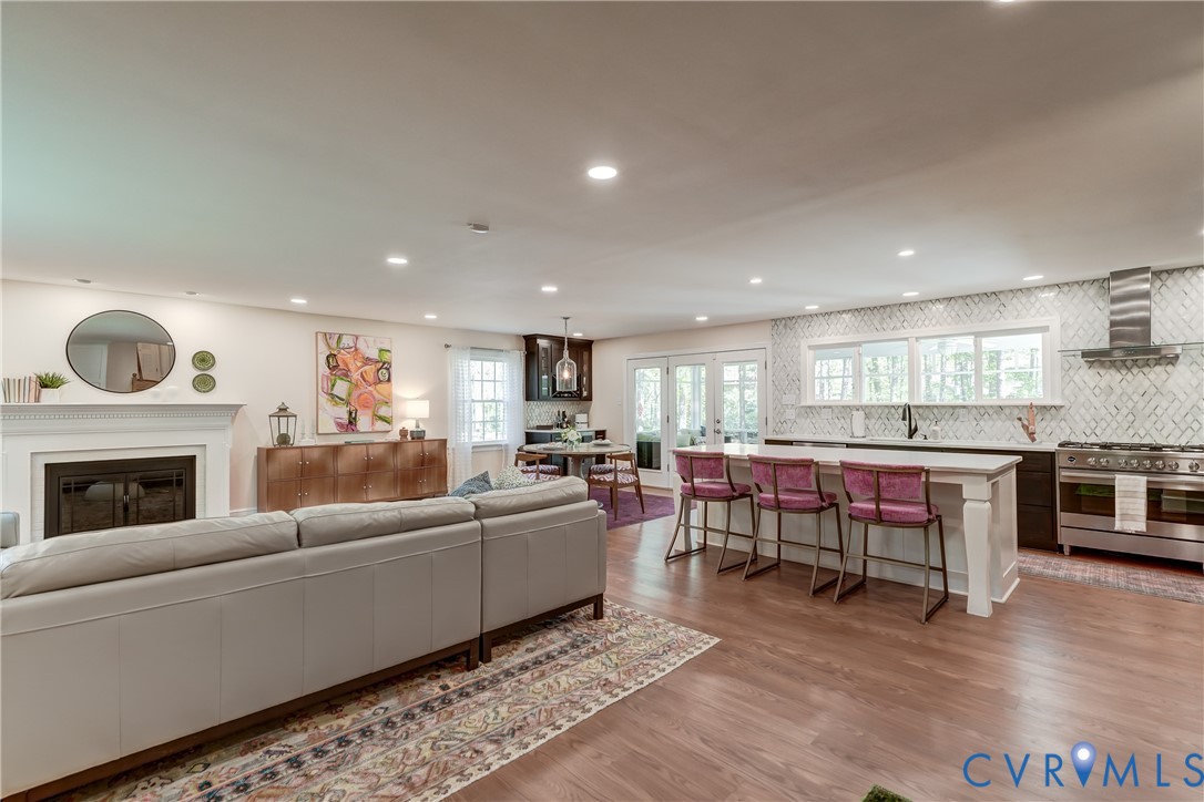 4287 Cheyenne Road Richmond, VA 23235 - Photo 24 of 60 a living room with furniture a fireplace and a kitchen view