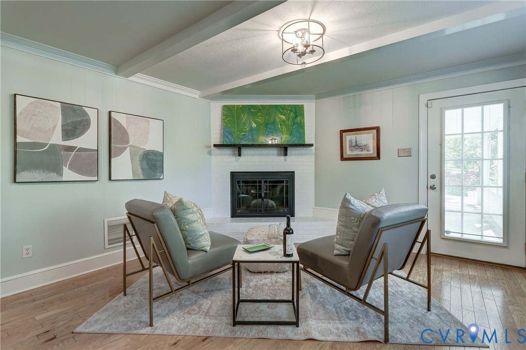 4287 Cheyenne Road Richmond, VA 23235 - Photo 42 of 60 a living room with furniture a flat screen tv and a fireplace