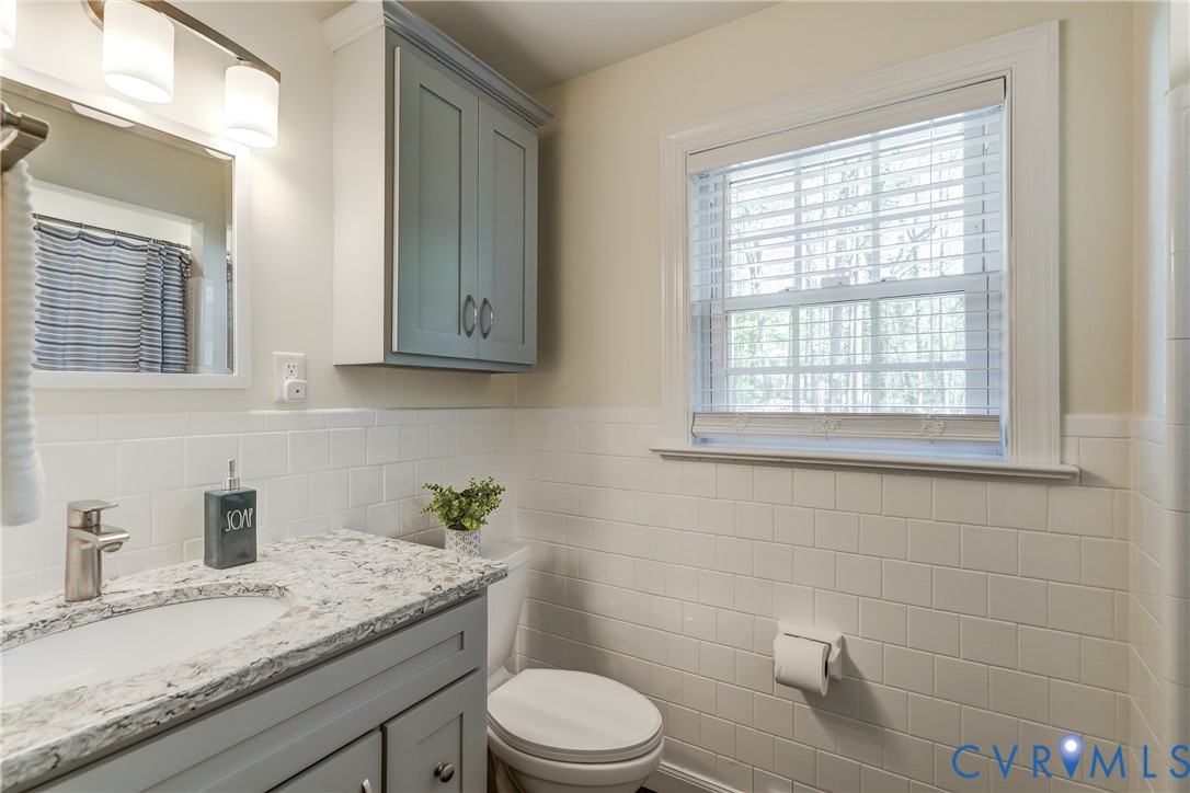 4287 Cheyenne Road Richmond, VA 23235 - Photo 46 of 60 a bathroom with a granite countertop toilet sink and mirror