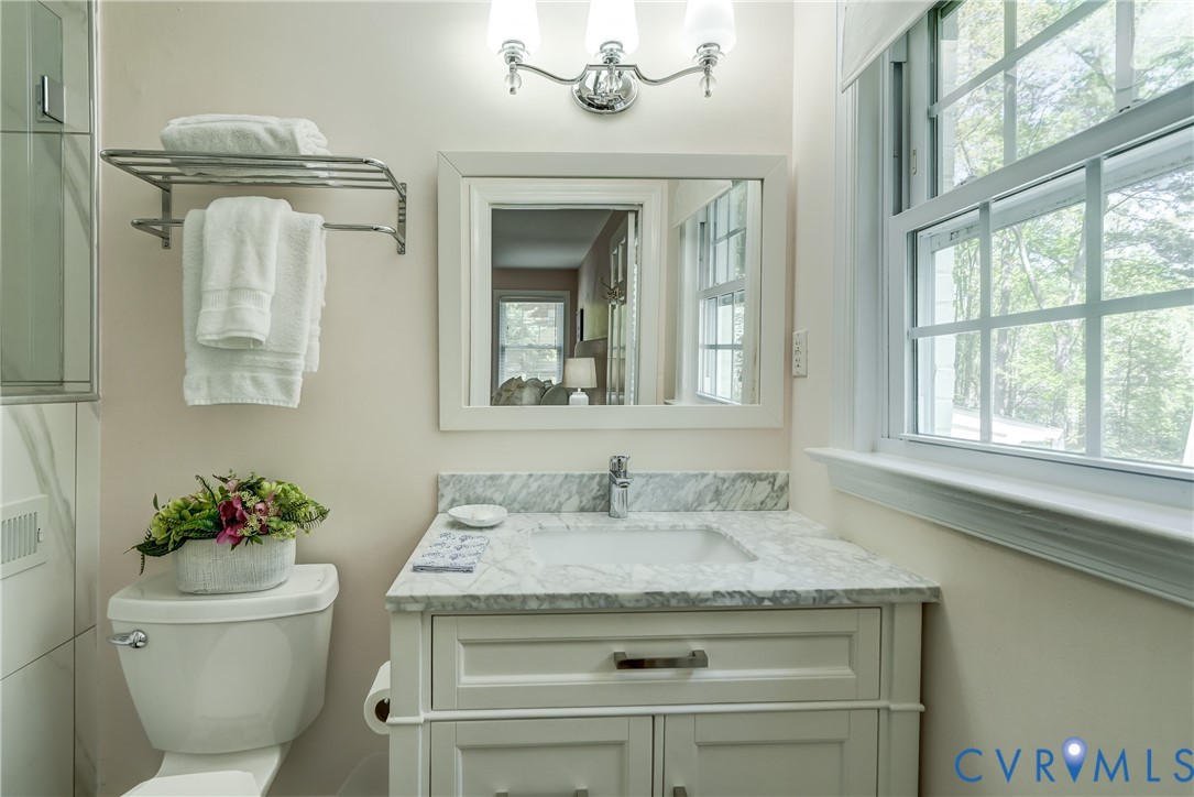 4287 Cheyenne Road Richmond, VA 23235 - Photo 50 of 60 a bathroom with a granite countertop sink a toilet and a mirror