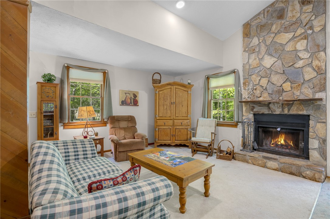 437 West Gate Road Pickens, SC 29671 - Photo 40 of 47 This inviting living room showcases a warm ambiance with a striking stone fireplace.