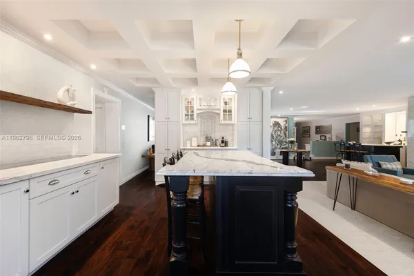 a kitchen with a sink a counter space and stainless steel appliances