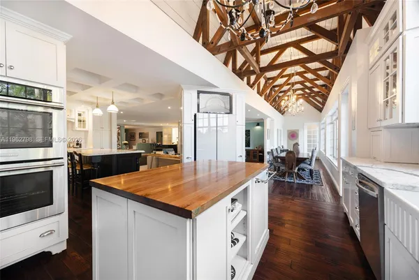 a kitchen with stainless steel appliances a stove a sink and a refrigerator