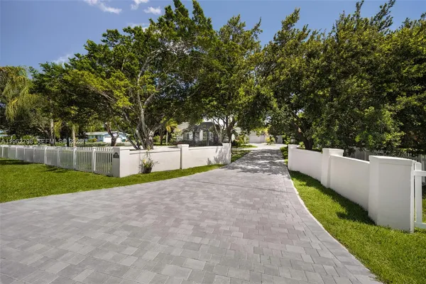 a view of a yard with large trees