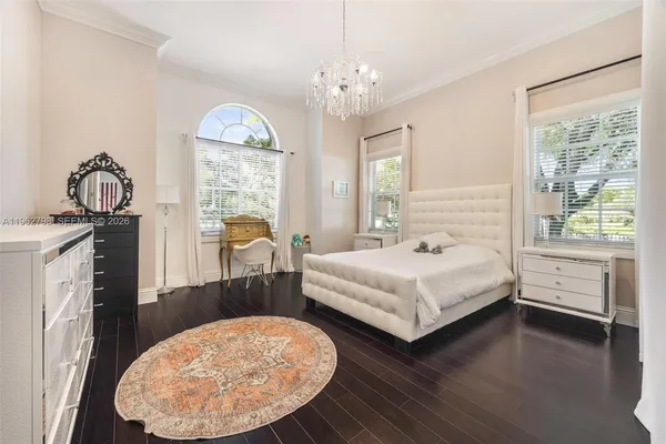 a bedroom with a bed and a chandelier