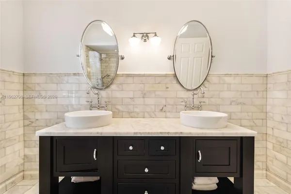 a bathroom with a double vanity sink and a mirror