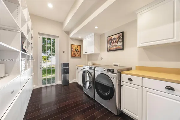 a view of washer and dryer with kitchen in the background