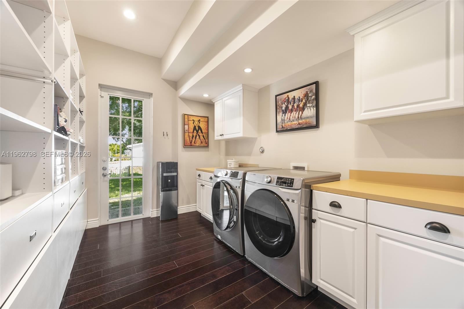 11000 Southwest 25th Street Davie, FL 33324 - Photo 34 of 45 a view of washer and dryer with kitchen in the background