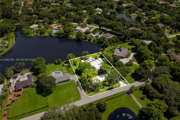 an aerial view of a house with a yard