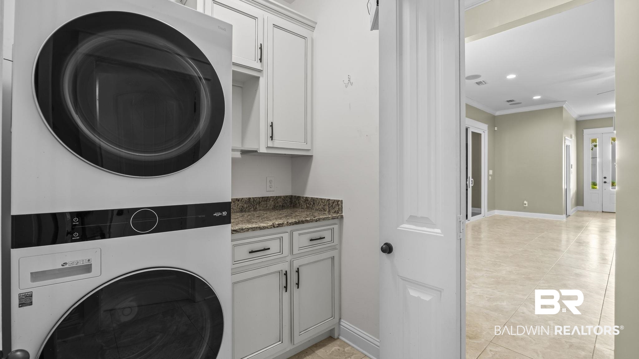 12361 Reunion Place Foley, AL 36535 - Photo 31 of 43 Laundry area featuring stacked washer / dryer, ornamental molding, cabinet space, and recessed lighting