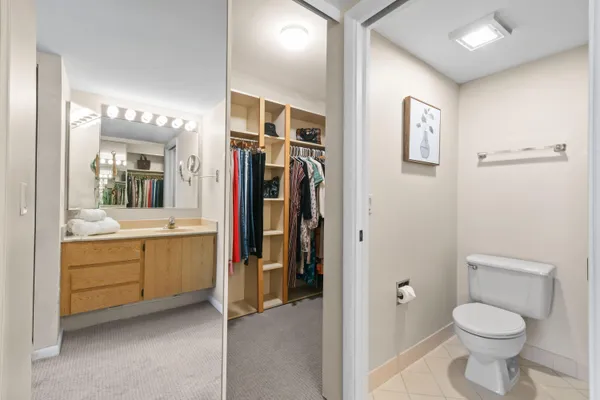 a bedroom with a bed and a ceiling fan