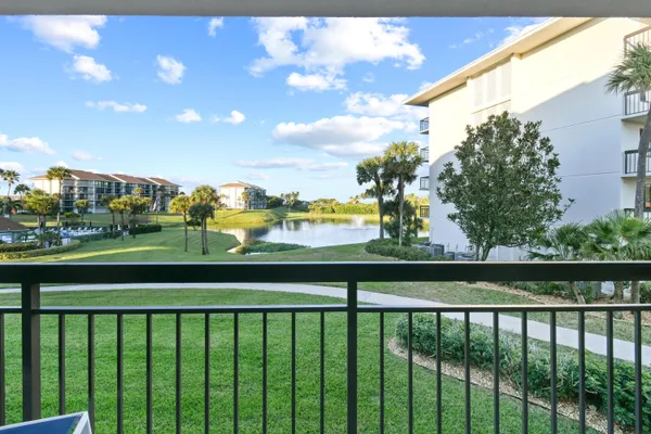 a view of a swimming pool with a patio and a yard