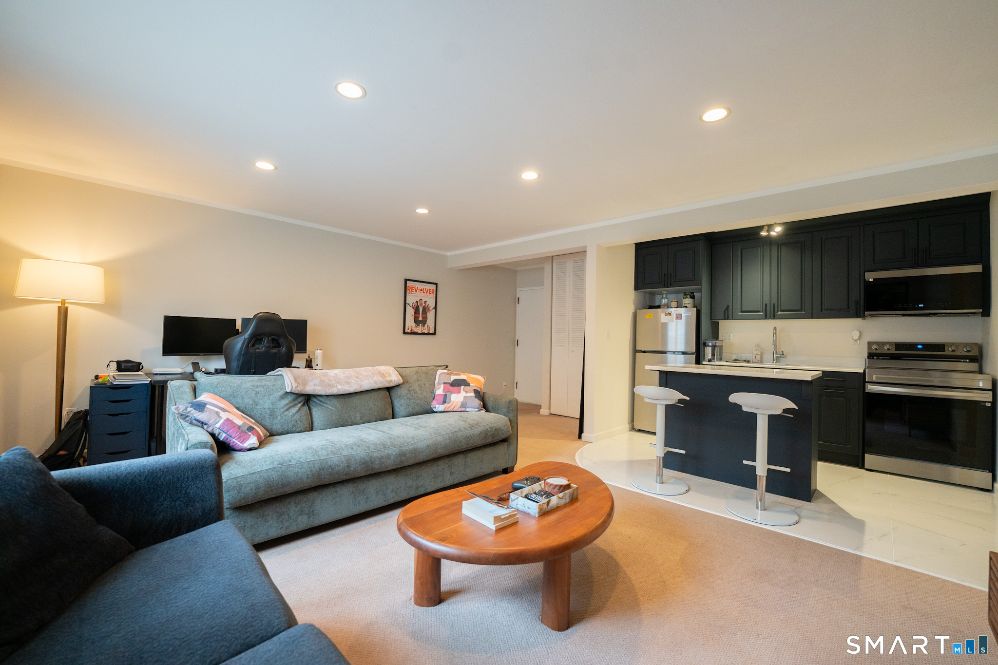 24 Home Court, Unit 4 Stamford, CT 06902 - Photo 4 of 18 a living room with furniture and a flat screen tv