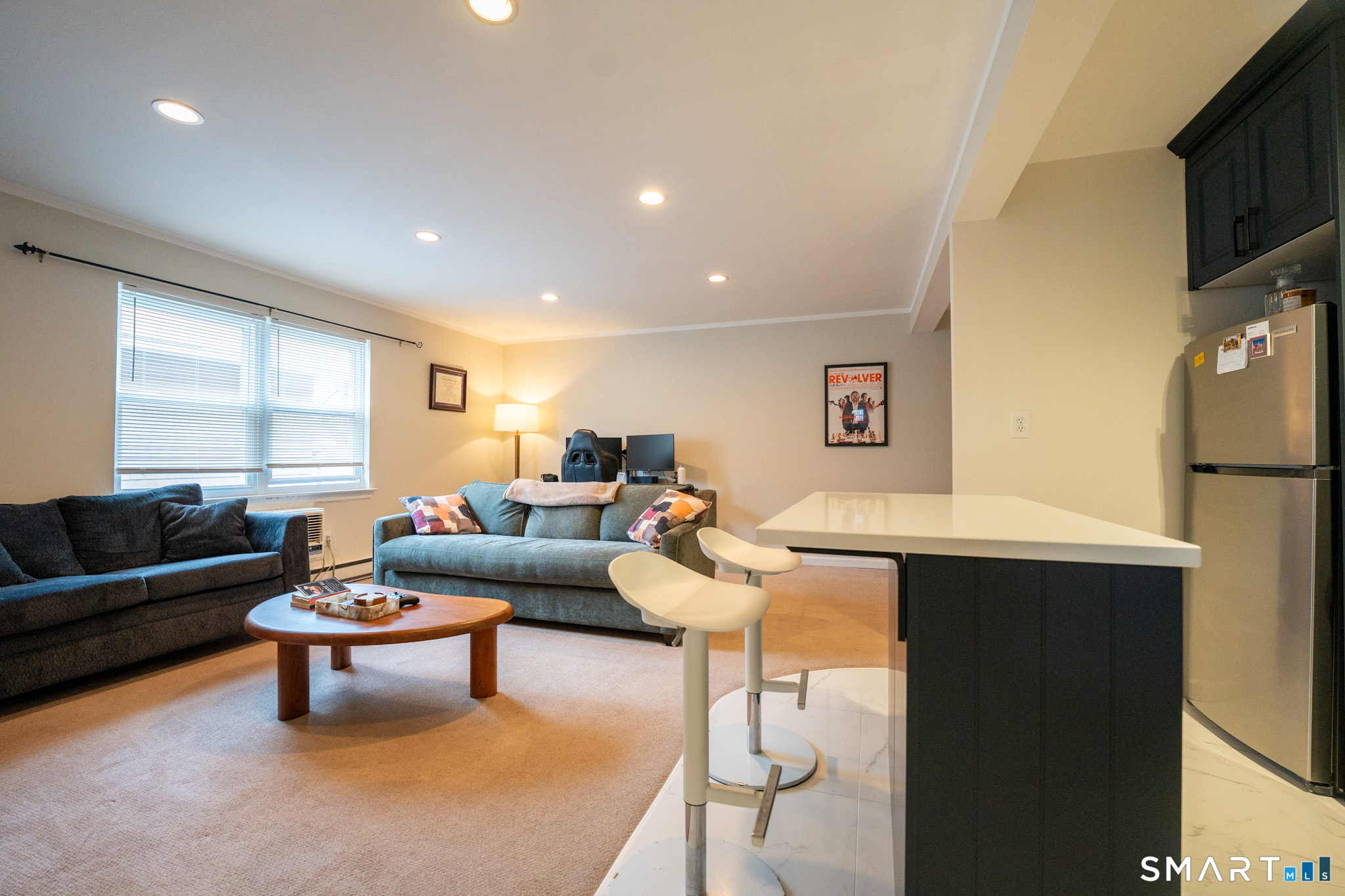 24 Home Court, Unit 4 Stamford, CT 06902 - Photo 5 of 18 a living room with furniture a window and a flat screen tv