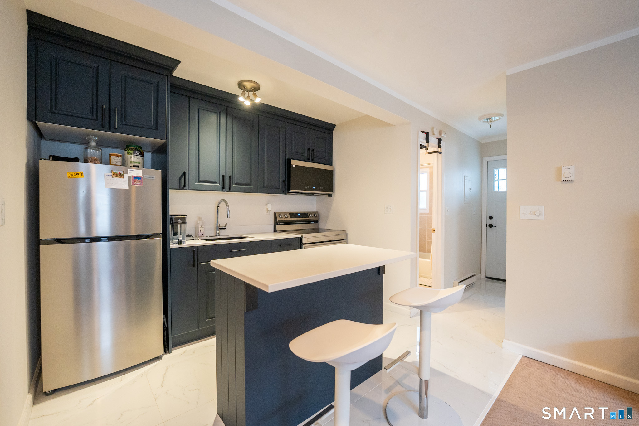 24 Home Court, Unit 4 Stamford, CT 06902 - Photo 8 of 18 a kitchen with a refrigerator a stove a sink and a cabinets